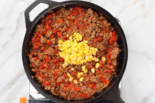 step 4: Add corn and de-glaze the pan