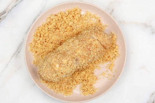 transfer the coated chicken roll to a mixture of breadcrumbs and butter