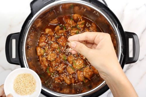 Step 5: Garnish and serve sesame chicken hot over rice.