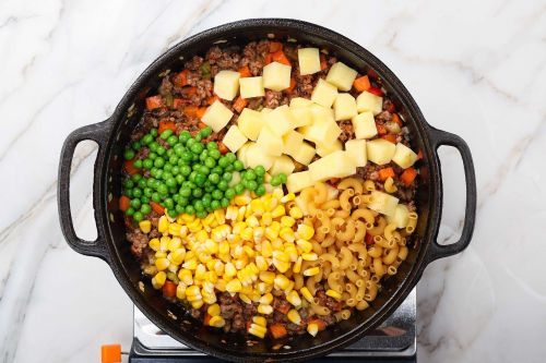 Step 4: Add the potatoes, peas, corn, and pasta.